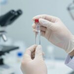 Scientist holding vial in laboratory